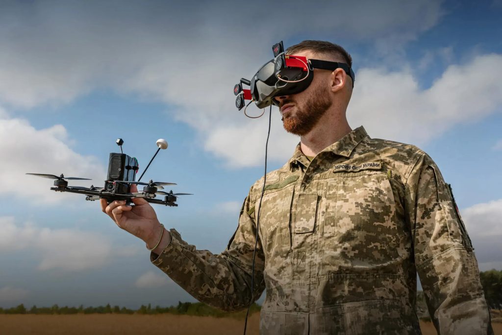 A Ukrainian service member operating an FPV drone with goggles