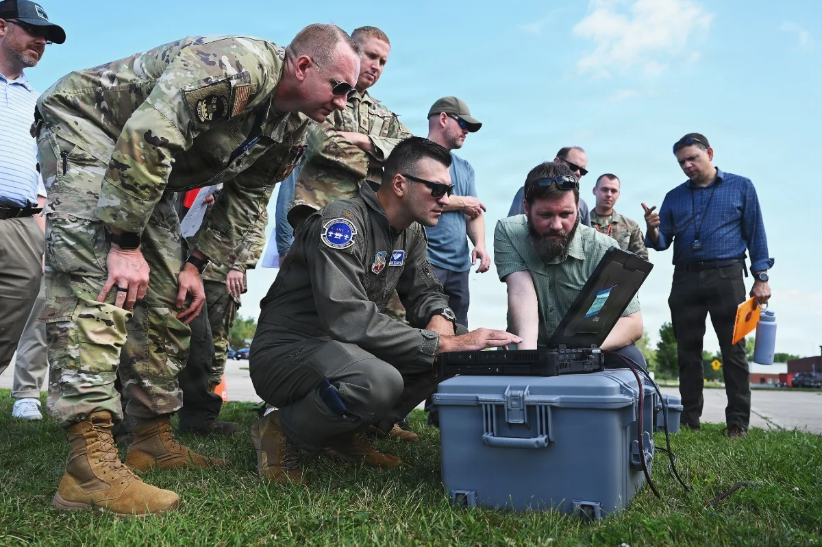 Military personnel and specialists evaluate the C2E portable control system prototype