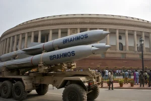 A launcher of BrahMos supersonic cruise missiles against the backdrop of the Parliament of India.