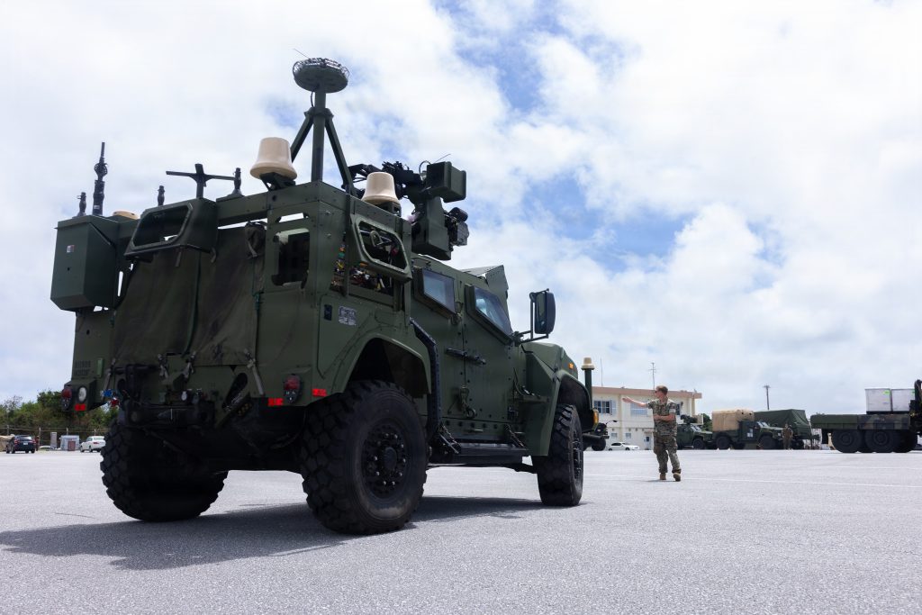 Lance Cpl. Charles Fiduccia ground guides a MADIS air defense system at Kadena Air Base in Okinawa