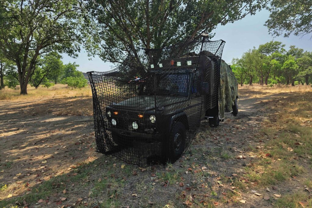Modernized ELVO Mercedes G-Class off-road vehicle featuring anti-drone protection and camouflage.