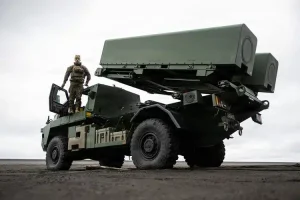 A service member on a Kongsberg StrikeMaster launcher on Jan Mayen island during NATO Arctic exercises.