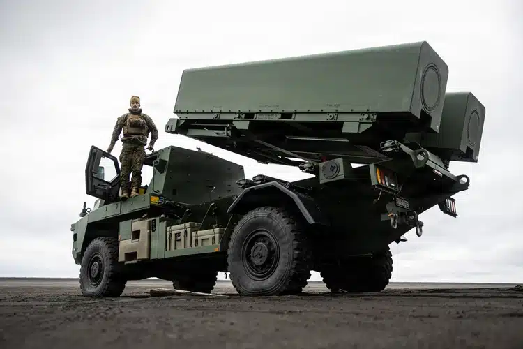 A service member on a Kongsberg StrikeMaster launcher on Jan Mayen island during NATO Arctic exercises.