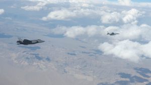 Anduril's Fury CCA drone flies alongside an F-35 Joint Strike Fighter during testing.