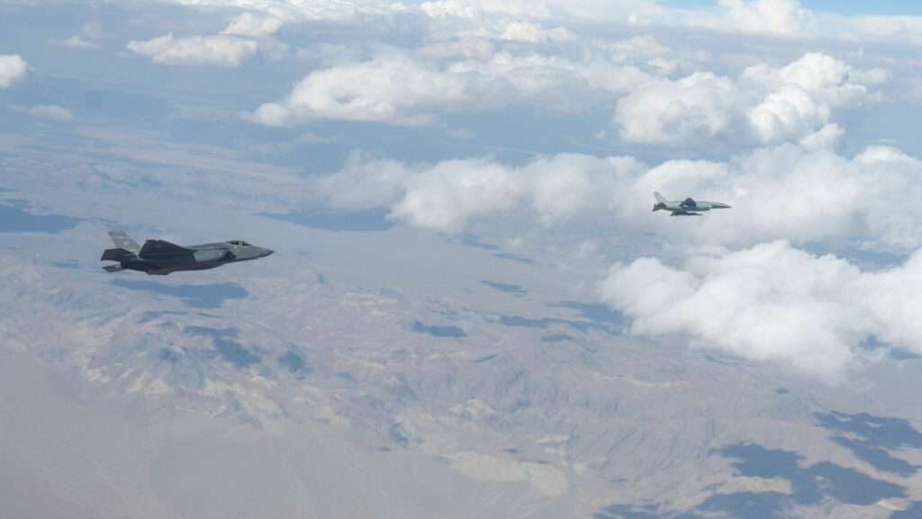 Anduril's Fury CCA drone flies alongside an F-35 Joint Strike Fighter during testing.