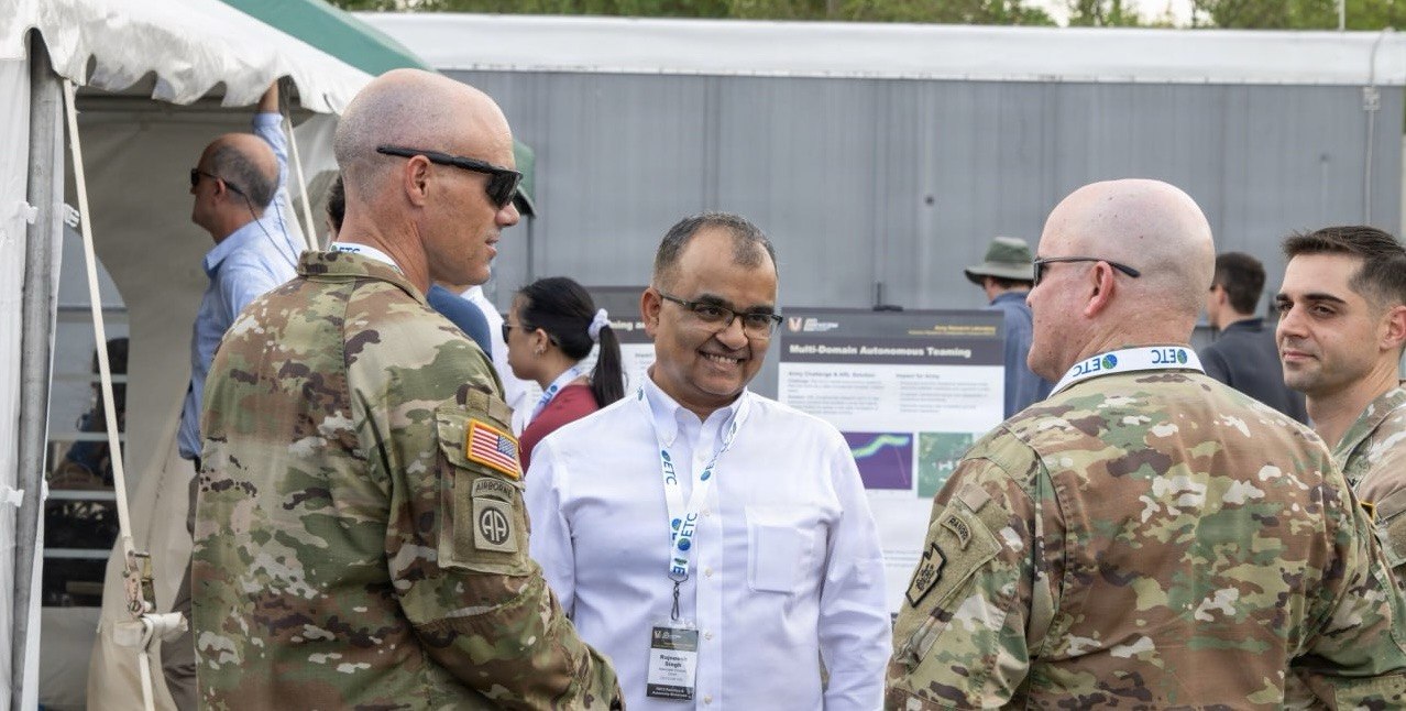 ARL's Dr. Rajeesh Singh discusses autonomous research with two Soldiers at Autonomy and Robotics Day