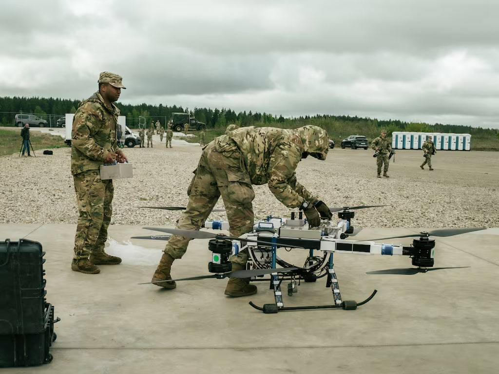 Soldiers change the batteries of a drone during a drone-based blood resupply as part of the multinational Hospital Exercise.